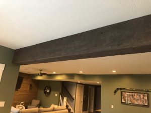 Hand hewn beam with dark stain