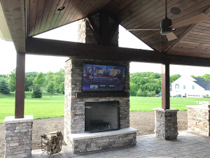 Open gable roof with stained ceiling and wood fireplace