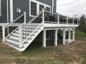 Island Mist decking with white fascia and post and beam wrap